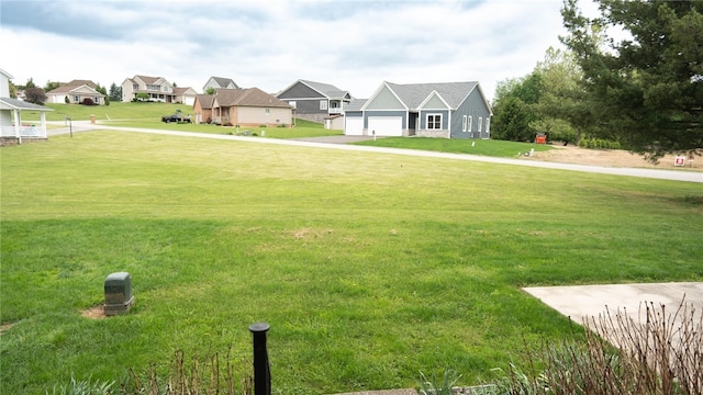 4895 Lucerne Rd, White Twp Ind, PA 15701 - view of grassy yard featuring a residential view, a garage, and driveway
