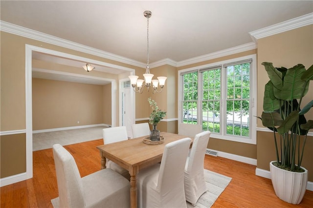 2214 Shannon Mills Dr, Connoquenessing Twp, PA 16053 - dining room featuring healthy amount of natural light, a chandelier, baseboards, light wood-type flooring, and ornamental molding