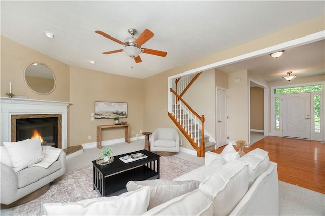 2214 Shannon Mills Dr, Connoquenessing Twp, PA 16053 - carpeted living room with stairway, ceiling fan, a high end fireplace, and baseboards