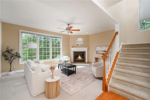 2214 Shannon Mills Dr, Connoquenessing Twp, PA 16053 - carpeted living room with ceiling fan, stairway, a glass covered fireplace, and baseboards