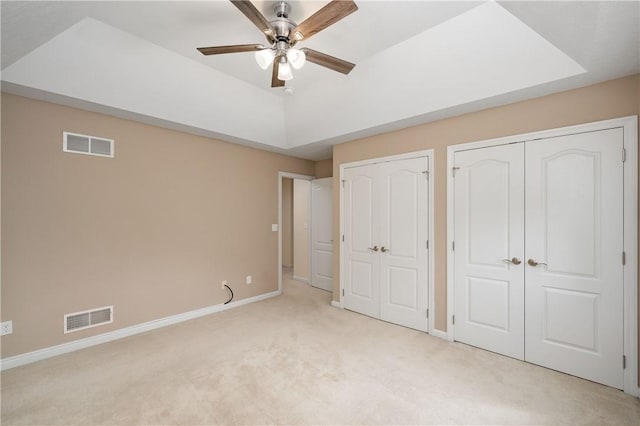 2214 Shannon Mills Dr, Connoquenessing Twp, PA 16053 - unfurnished bedroom featuring light carpet, multiple closets, baseboards, and a ceiling fan