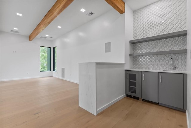409 Fox Chapel Rd, Fox Chapel, PA 15238 - indoor wet bar featuring beam ceiling, light wood finished floors, decorative backsplash, baseboards, and recessed lighting
