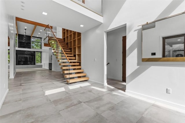409 Fox Chapel Rd, Fox Chapel, PA 15238 - entryway featuring a fireplace, washer / clothes dryer, stairs, baseboards, and recessed lighting