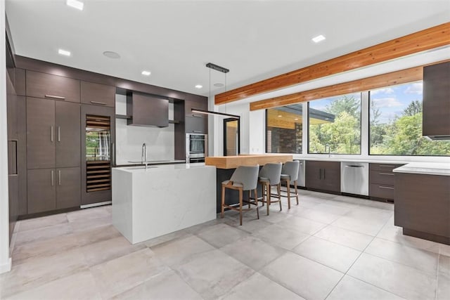 409 Fox Chapel Rd, Fox Chapel, PA 15238 - kitchen featuring modern cabinets, light countertops, a center island with sink, appliances with stainless steel finishes, and recessed lighting