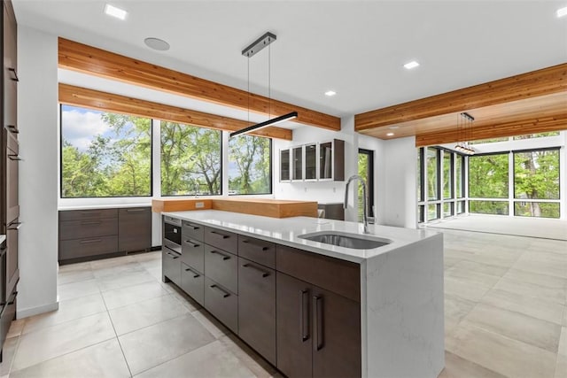 409 Fox Chapel Rd, Fox Chapel, PA 15238 - kitchen with a sink, modern cabinets, recessed lighting, beamed ceiling, and hanging light fixtures