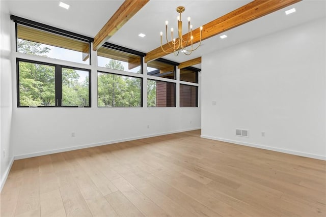 409 Fox Chapel Rd, Fox Chapel, PA 15238 - empty room featuring beam ceiling, healthy amount of natural light, light wood finished floors, a chandelier, and baseboards