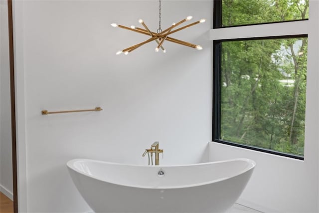409 Fox Chapel Rd, Fox Chapel, PA 15238 - bathroom with healthy amount of natural light, a chandelier, and a soaking tub