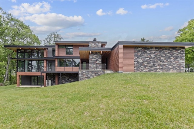 409 Fox Chapel Rd, Fox Chapel, PA 15238 - back of house featuring a yard, a sunroom, and stone siding