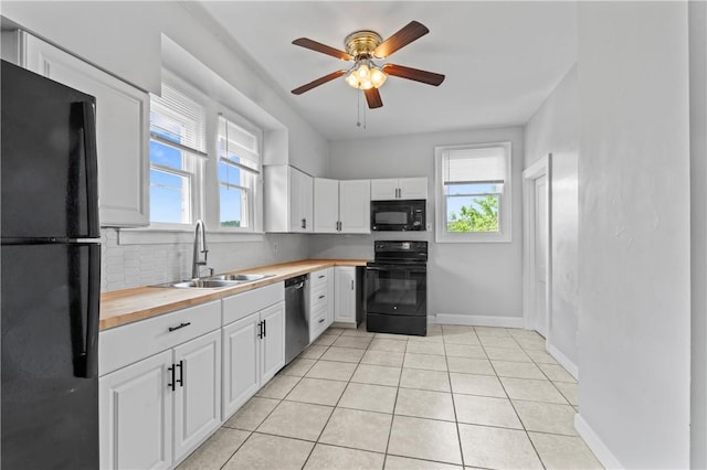 947 Pine St, Ambridge, PA 15003 - kitchen with black appliances, a sink, butcher block counters, and plenty of natural light