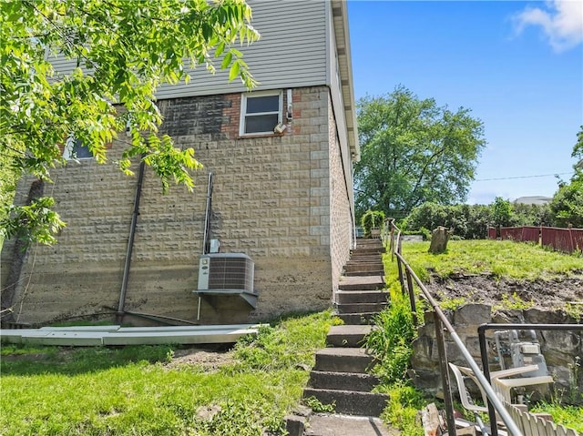 947 Pine St, Ambridge, PA 15003 - view of side of home featuring stairway, brick siding, and central air condition unit