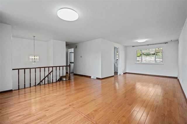 440 Perrymont, Mccandless, PA 15237 - empty room with a chandelier, light wood-style flooring, and baseboards