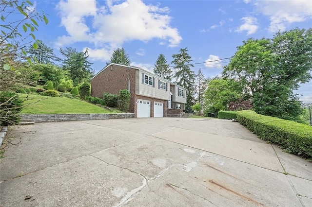 440 Perrymont, Mccandless, PA 15237 - view of side of property with a garage, brick siding, a lawn, and concrete driveway