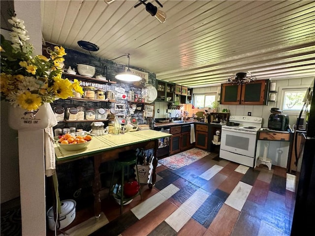 1641 Clintonville Rd, Irwin Twp, PA 16038 - kitchen with white range with electric stovetop, freestanding refrigerator, dark wood-style flooring, a sink, and glass insert cabinets