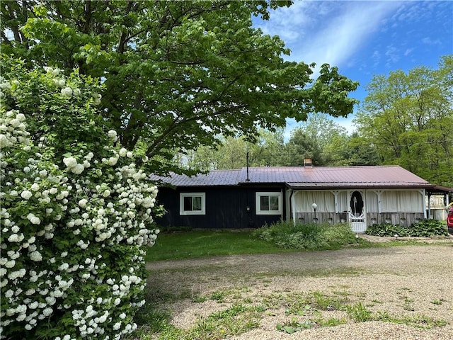 1641 Clintonville Rd, Irwin Twp, PA 16038 - view of front of house with board and batten siding and a chimney