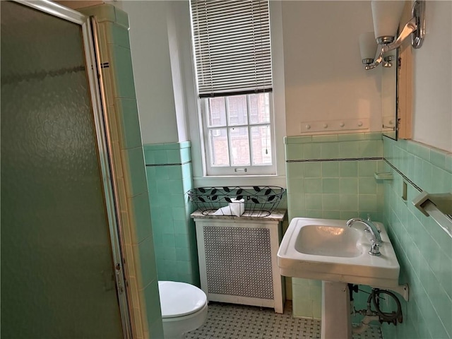166 N Dithridge St Unit 2A, Oakland, PA 15213 - bathroom featuring tile walls, toilet, a shower stall, and wainscoting