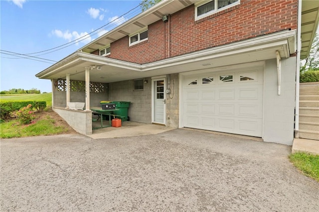 128 Wise Rd, City Of But Se, PA 16002 - view of property exterior featuring driveway, brick siding, a garage, and concrete block siding
