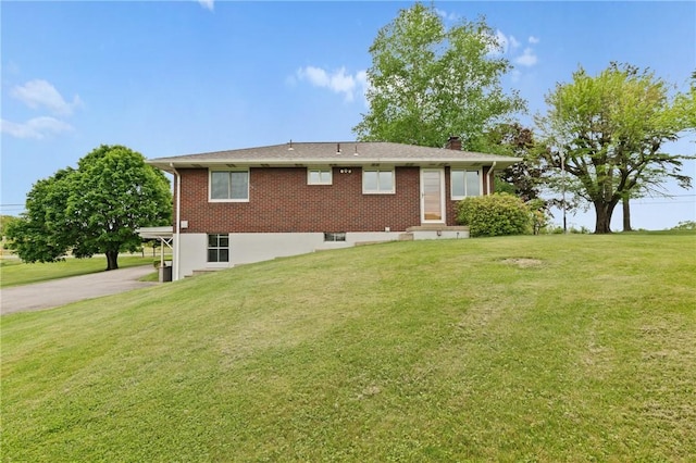 128 Wise Rd, City Of But Se, PA 16002 - rear view of house with a chimney, a lawn, driveway, and brick siding