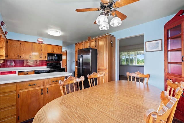 128 Wise Rd, City Of But Se, PA 16002 - kitchen featuring black appliances, ceiling fan, light countertops, tasteful backsplash, and brown cabinets