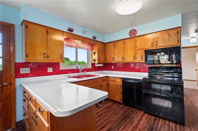 128 Wise Rd, City Of But Se, PA 16002 - kitchen featuring black appliances, a sink, a peninsula, light countertops, and dark wood-type flooring