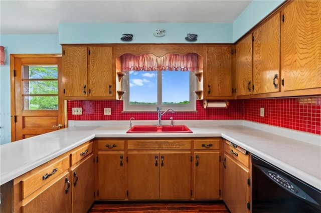 128 Wise Rd, City Of But Se, PA 16002 - kitchen with black dishwasher, a sink, light countertops, decorative backsplash, and brown cabinetry