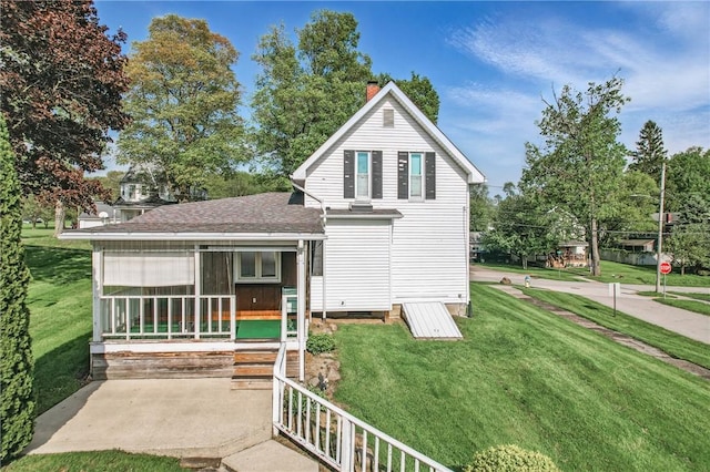 601 Depot St, Jamestown, PA 16134 - view of front of home featuring a chimney, a front lawn, a sunroom, roof with shingles, and crawl space