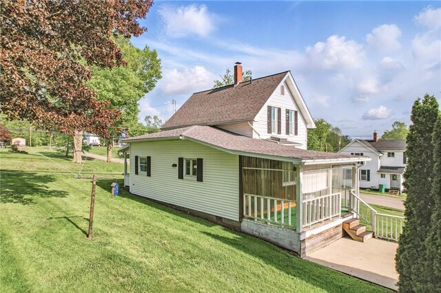 601 Depot St, Jamestown, PA 16134 - rear view of property with a sunroom, roof with shingles, a chimney, and a yard