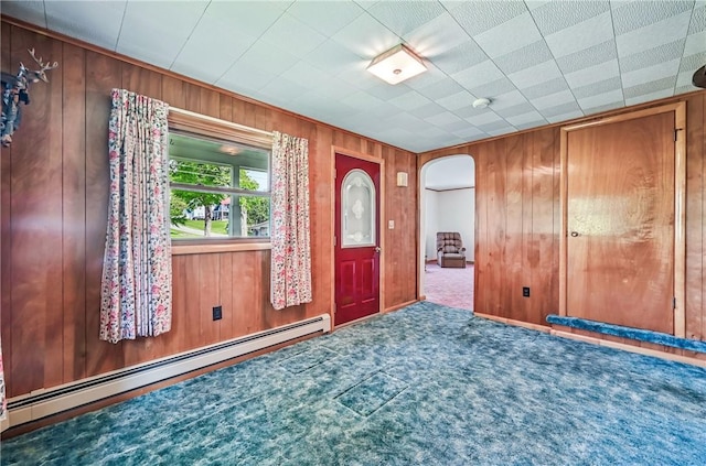 601 Depot St, Jamestown, PA 16134 - entryway featuring a baseboard radiator, arched walkways, wooden walls, and carpet
