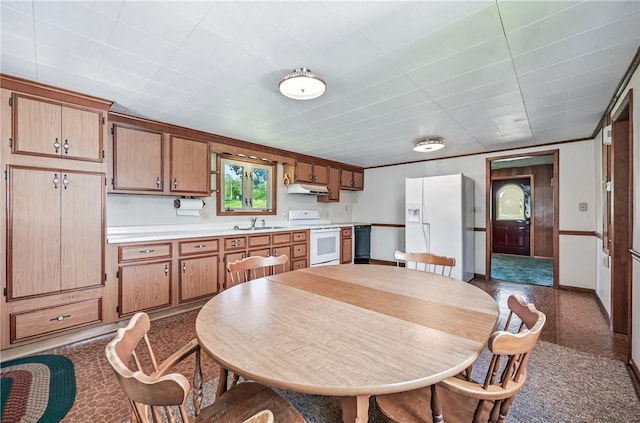 601 Depot St, Jamestown, PA 16134 - kitchen with white appliances, under cabinet range hood, light countertops, a sink, and brown cabinets