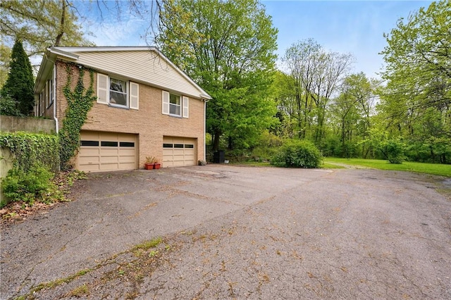 3080 Eldogor Ln, Neshannock Twp, PA 16105 - view of side of home with brick siding, driveway, and an attached garage