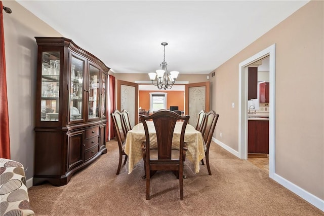 244 Elmtree Rd, New Kensington, PA 15068 - dining space with a chandelier, light colored carpet, and baseboards