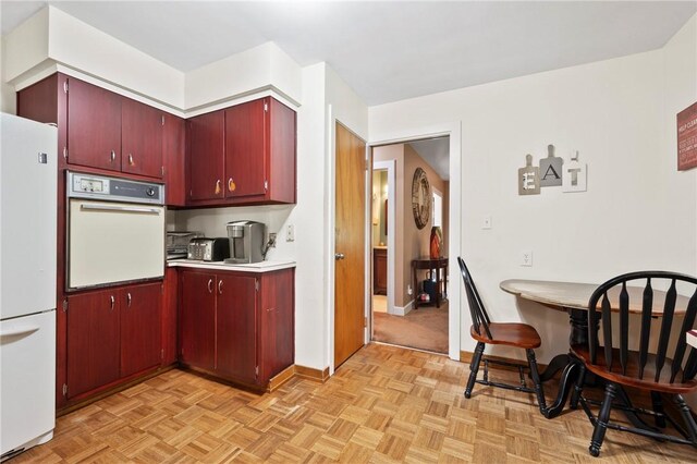 244 Elmtree Rd, New Kensington, PA 15068 - kitchen featuring white appliances, red cabinetry, light countertops, and baseboards