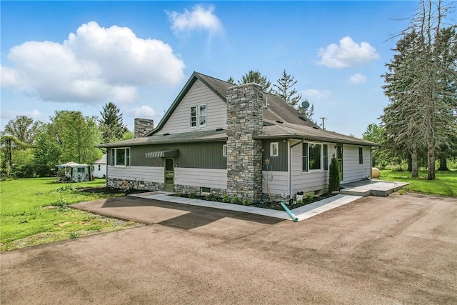 13035 State Highway 618, Conneaut Lake Cra, PA 16316 - view of side of property with a chimney, a lawn, and roof with shingles