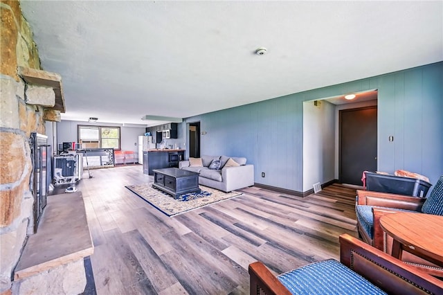 13035 State Highway 618, Conneaut Lake Cra, PA 16316 - living area featuring wood finished floors and a stone fireplace