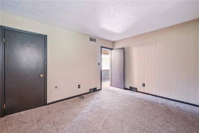 13035 State Highway 618, Conneaut Lake Cra, PA 16316 - spare room featuring a textured ceiling, carpet floors, and baseboards