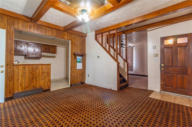 2605 Fayette St, Mckeesport, PA 15132 - carpeted entrance foyer with wooden walls, stairway, beamed ceiling, and baseboards