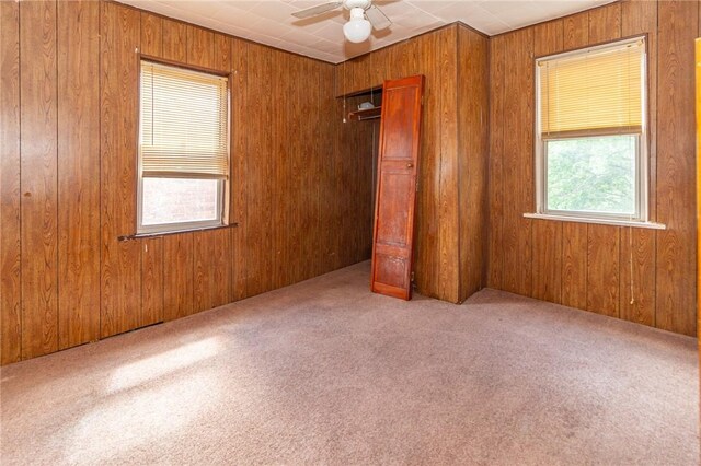 2605 Fayette St, Mckeesport, PA 15132 - unfurnished bedroom featuring carpet flooring, wood walls, a closet, and ceiling fan