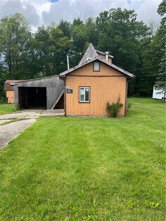227 Woodlands Rd, Connoquenessing Twp, PA 16033 - view of pole building with driveway and a yard
