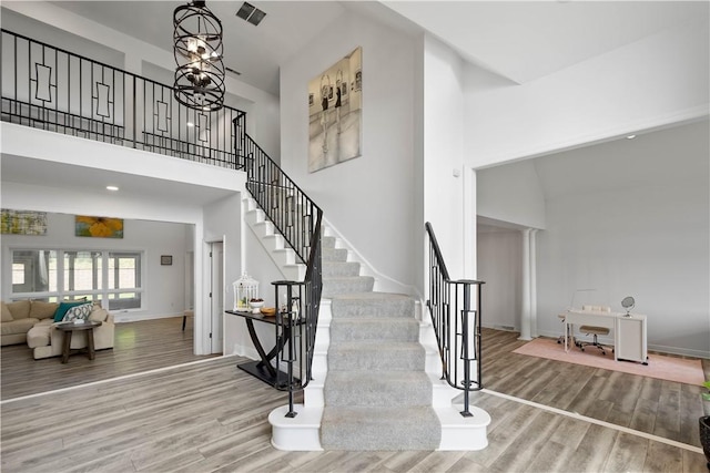323 Snowberry Cir, Peters Twp, PA 15367 - stairway with wood finished floors, baseboards, and a towering ceiling