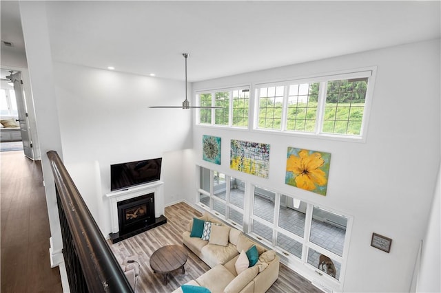 323 Snowberry Cir, Peters Twp, PA 15367 - living area with ceiling fan, wood finished floors, a glass covered fireplace, and recessed lighting