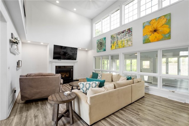 323 Snowberry Cir, Peters Twp, PA 15367 - living area with a towering ceiling, a fireplace, wood finished floors, and recessed lighting