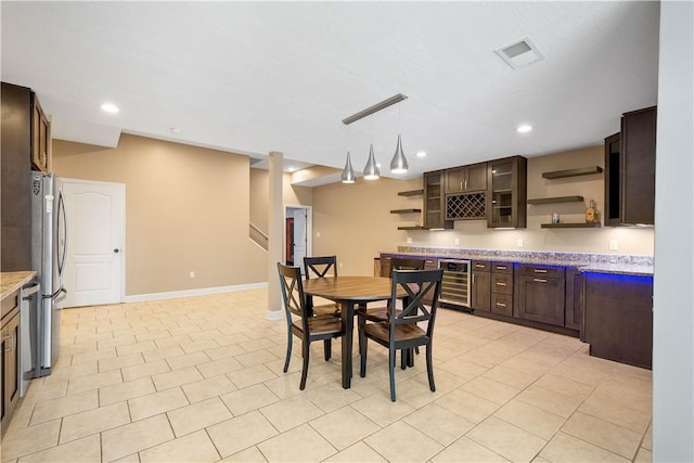 323 Snowberry Cir, Peters Twp, PA 15367 - dining room with wine cooler, bar with sink, light tile patterned floors, recessed lighting, and baseboards