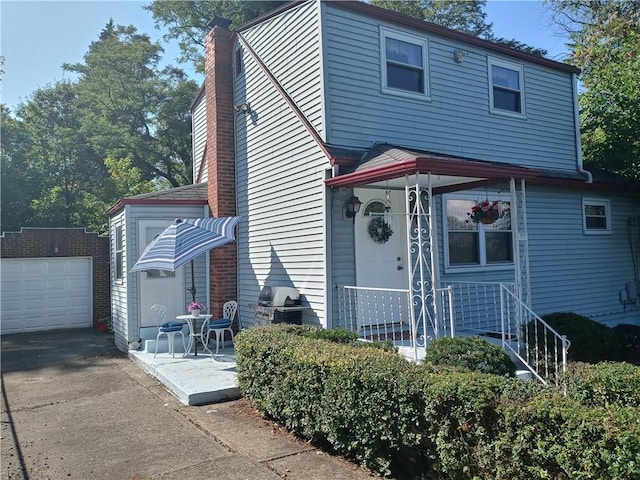 507 Bon Air Rd, Penn Hills, PA 15235 - view of front facade with a chimney, an outbuilding, driveway, and a garage
