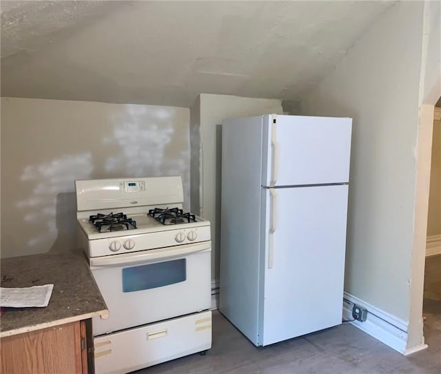 601 N Ave, Wilkinsburg, PA 15221 - kitchen featuring white appliances, brown cabinetry, and lofted ceiling
