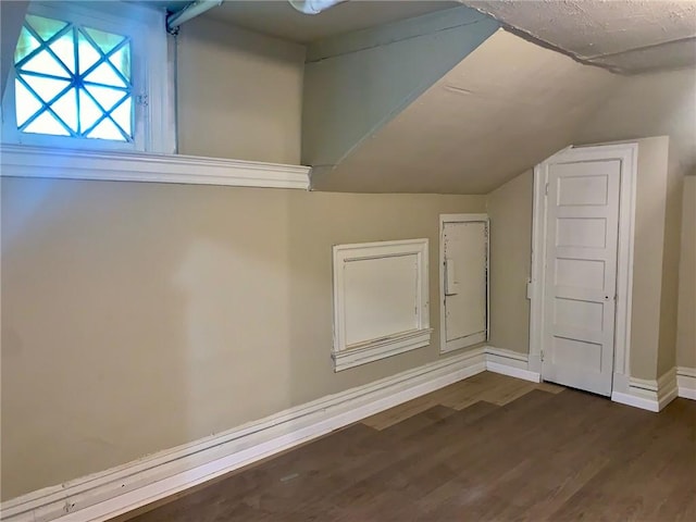 601 N Ave, Wilkinsburg, PA 15221 - additional living space with dark wood-style floors, vaulted ceiling, and baseboards