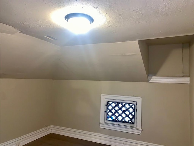601 N Ave, Wilkinsburg, PA 15221 - bonus room with a textured ceiling, baseboards, dark wood-type flooring, and vaulted ceiling