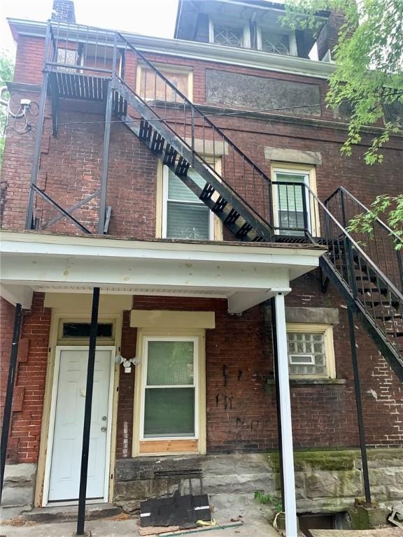 601 N Ave, Wilkinsburg, PA 15221 - rear view of property featuring stairs and brick siding