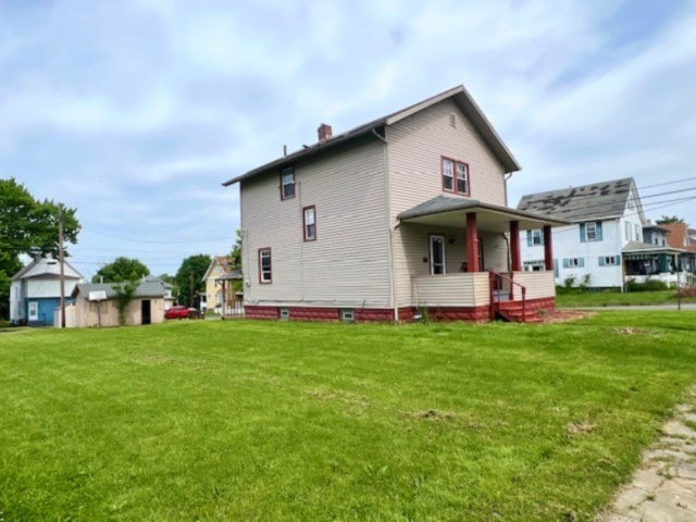 582 Spruce Ave, Sharon, PA 16146 - back of property with a porch, a chimney, and a yard