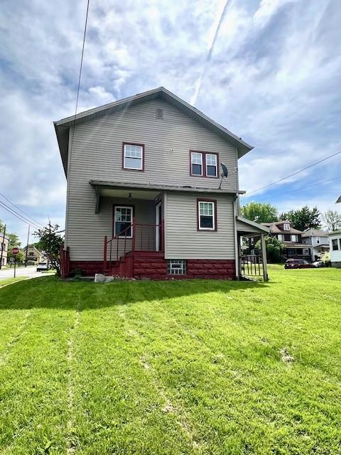 582 Spruce Ave, Sharon, PA 16146 - rear view of house featuring a lawn