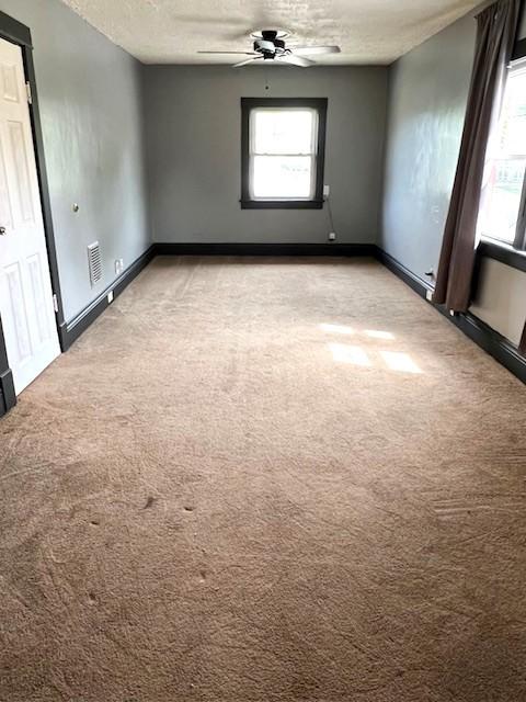 582 Spruce Ave, Sharon, PA 16146 - unfurnished room featuring light colored carpet, baseboards, ceiling fan, and a textured ceiling