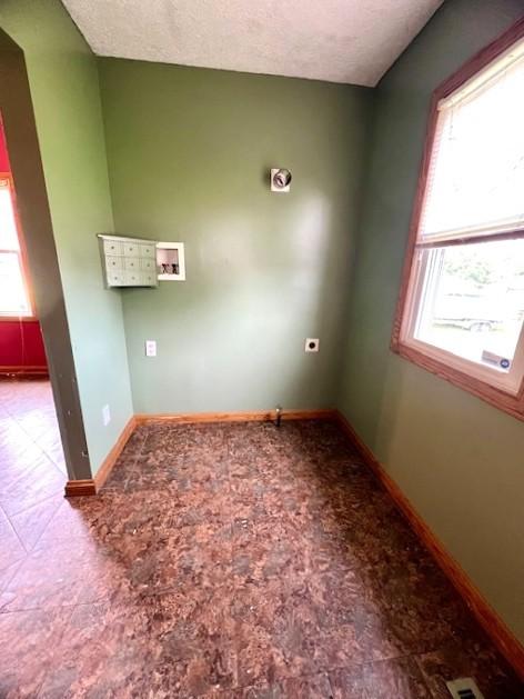 582 Spruce Ave, Sharon, PA 16146 - empty room with plenty of natural light, baseboards, and a textured ceiling